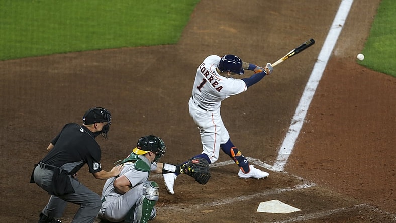 Apr 8, 2021; Houston, Texas, USA; Houston Astros shortstop Carlos Correa (1) hits an RBI double against the Oakland Athletics during the fourth inning at Minute Maid Park. Mandatory Credit: Thomas Shea-USA TODAY Sports