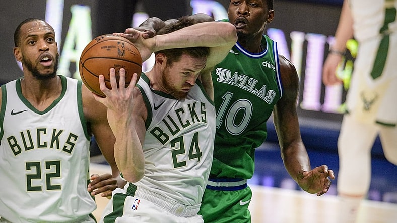 Apr 8, 2021; Dallas, Texas, USA; Milwaukee Bucks guard Pat Connaughton (24) and Dallas Mavericks forward Dorian Finney-Smith (10) fight for the rebound during the second quarter at the American Airlines Center. Mandatory Credit: Jerome Miron-USA TODAY Sports