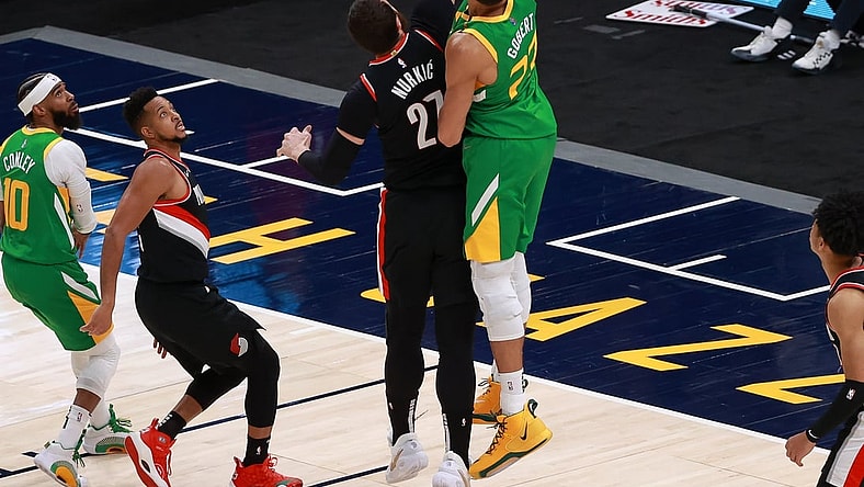 Apr 8, 2021; Salt Lake City, Utah, USA; Utah Jazz center Rudy Gobert (27) taps the ball in for a basket against Portland Trail Blazers center Jusuf Nurkic (27) during the second quarter at Vivint Smart Home Arena. Mandatory Credit: Chris Nicoll-USA TODAY Sports