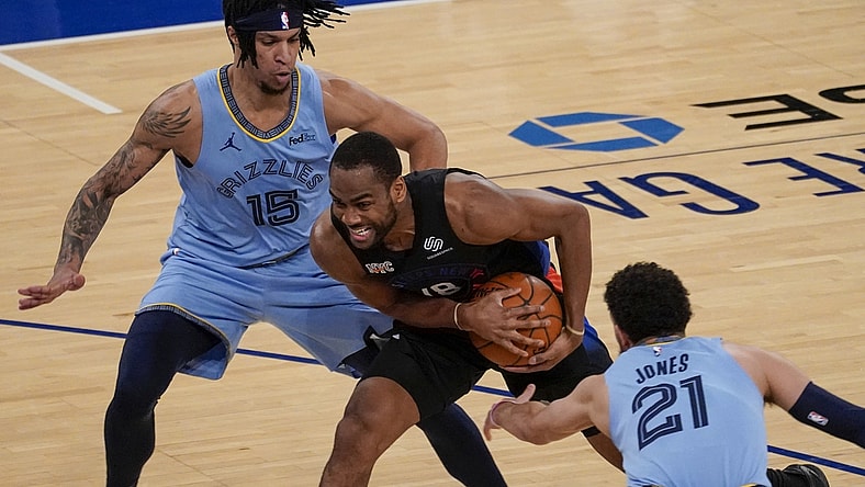 Apr 9, 2021; New York, New York, USA; New York Knicks guard Alec Burks (18) drives against Memphis Grizzlies forward Brandon Clarke (15) and guard Tyus Jones (21) in the first half at Madison Square Garden. Mandatory Credit: Mary Altaffer-Pool Photo via USA TODAY Sports