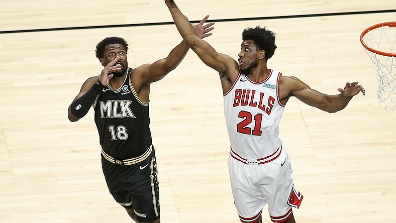 Apr 9, 2021; Atlanta, Georgia, USA; Chicago Bulls forward Thaddeus Young (21) grabs a rebound past Atlanta Hawks forward Solomon Hill (18) in the first quarter at State Farm Arena. Mandatory Credit: Brett Davis-USA TODAY Sports