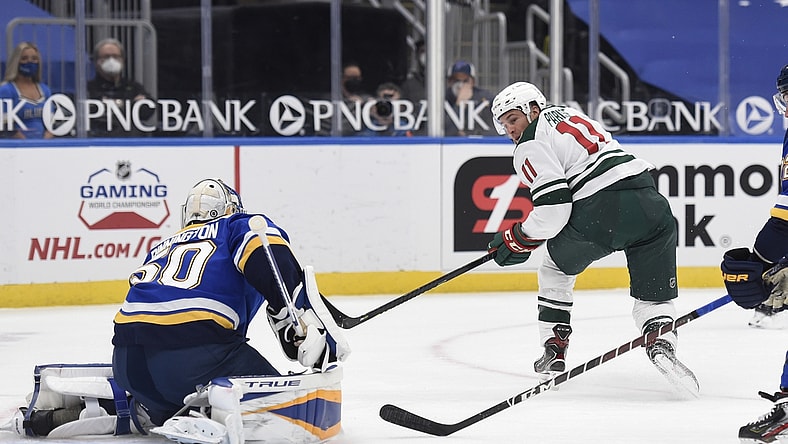 Apr 9, 2021; St. Louis, Missouri, USA; Minnesota Wild left wing Zach Parise (11) takes a shot on St. Louis Blues goaltender Jordan Binnington (50) in the first period at Enterprise Center. Mandatory Credit: Joe Puetz-USA TODAY Sports