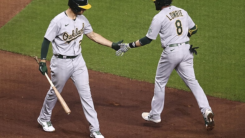 Apr 9, 2021; Houston, Texas, USA; Oakland Athletics second baseman Jed Lowrie (8) celebrates with first baseman Matt Olson (28) after hitting a home run during the fourth inning against the Houston Astros at Minute Maid Park. Mandatory Credit: Troy Taormina-USA TODAY Sports