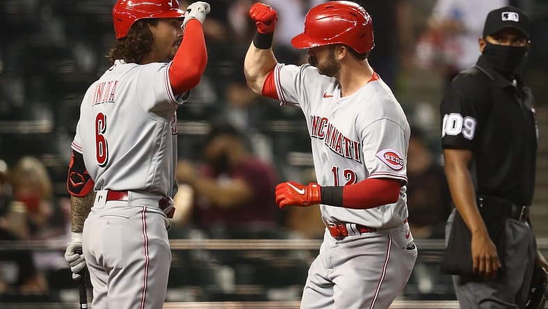 Apr 9, 2021; Phoenix, Arizona, USA; Cincinnati Reds outfielder Tyler Naquin (right) celebrates with Jonathan India after hitting a solo home run in the fourth inning against the Arizona Diamondbacks during opening day at Chase Field. Mandatory Credit: Mark J. Rebilas-USA TODAY Sports