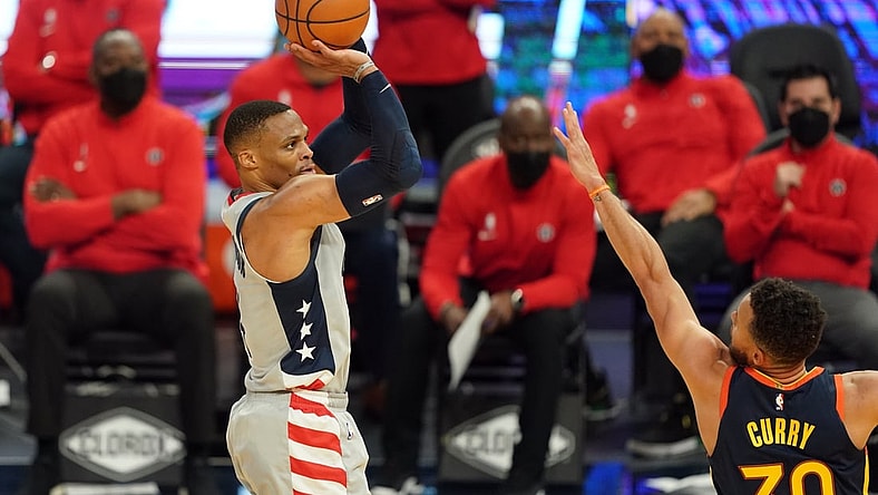 Apr 9, 2021; San Francisco, California, USA; Washington Wizards guard Russell Westbrook (4) shoots over Golden State Warriors guard Stephen Curry (30) during the second quarter at Chase Center. Mandatory Credit: Darren Yamashita-USA TODAY Sports