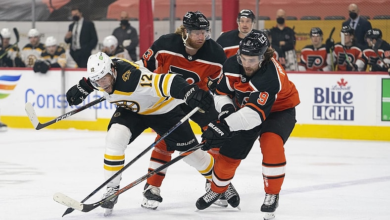 Apr 10, 2021; Philadelphia, Pennsylvania, USA; Boston Bruins right wing Craig Smith (12) battles for the puck against Philadelphia Flyers right wing Jakub Voracek (93) and defenseman Ivan Provorov (9) in the first period at the Wells Fargo Center. Mandatory Credit: Mitchell Leff-USA TODAY Sports