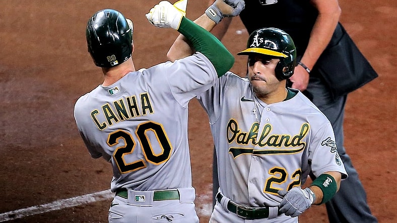 Apr 10, 2021; Houston, Texas, USA; Oakland Athletics center fielder Ramon Laureano (22, right) is congratulated by Oakland Athletics left fielder Mark Canha (20) after hitting a two-run home run against the Houston Astros during the fifth inning at Minute Maid Park. Mandatory Credit: Erik Williams-USA TODAY Sports