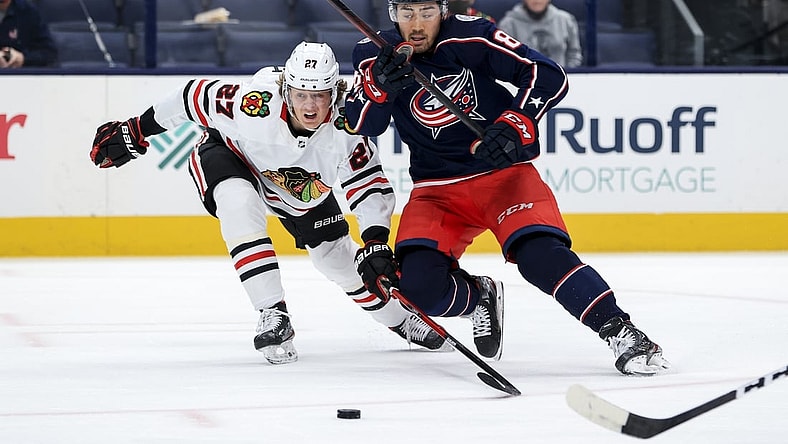 Apr 10, 2021; Columbus, Ohio, USA; Columbus Blue Jackets right winger Kole Sherwood (88) battles for the puck against Chicago Blackhawks defenseman Adam Boqvist (27) in the first period at Nationwide Arena. Mandatory Credit: Aaron Doster-USA TODAY Sports