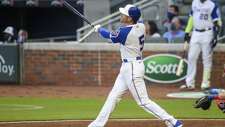 Apr 10, 2021; Atlanta, Georgia, USA; Atlanta Braves first baseman Freddie Freeman (5) hits a two run home run against the Philadelphia Phillies in the first inning at Truist Park. Mandatory Credit: Brett Davis-USA TODAY Sports
