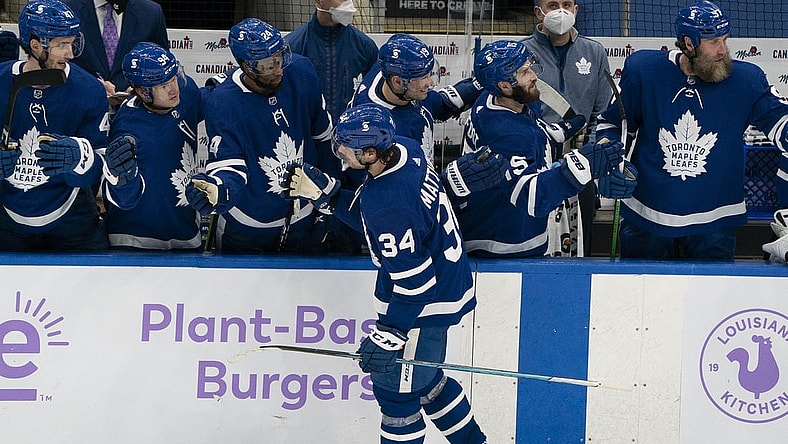Apr 10, 2021; Toronto, Ontario, CAN; Toronto Maple Leafs center Auston Matthews (34) celebrates at the bench after scoring a third goal against the Ottawa Senators during the second period at Scotiabank Arena. Mandatory Credit: Nick Turchiaro-USA TODAY Sports