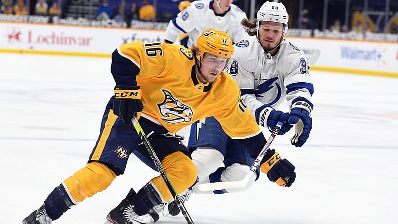 Apr 10, 2021; Nashville, Tennessee, USA; Nashville Predators center Rem Pitlick (16) skates with the puck past pressure from Tampa Bay Lightning defenseman Mikhail Sergachev (98) during the first period at Bridgestone Arena. Mandatory Credit: Christopher Hanewinckel-USA TODAY Sports
