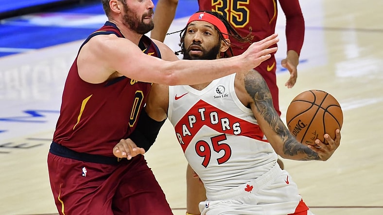 Apr 10, 2021; Cleveland, Ohio, USA; Toronto Raptors guard DeAndre' Bembry (95) moves to the basket against Cleveland Cavaliers forward Kevin Love (0) during the third quarter at Rocket Mortgage FieldHouse. Mandatory Credit: Ken Blaze-USA TODAY Sports
