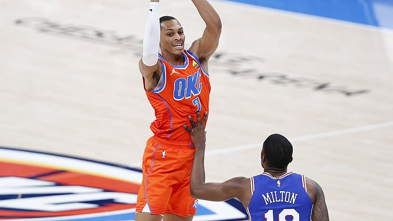 Apr 10, 2021; Oklahoma City, Oklahoma, USA; Oklahoma City Thunder forward Darius Bazley (7) passes the ball over Philadelphia 76ers guard Shake Milton (18) during the second quarter at Chesapeake Energy Arena. Mandatory Credit: Alonzo Adams-USA TODAY Sports