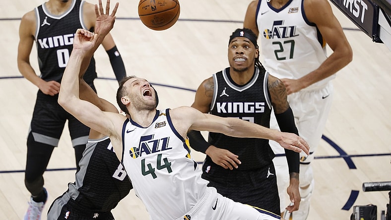 Apr 10, 2021; Salt Lake City, Utah, USA; Utah Jazz forward Bojan Bogdanovic (44) drives against Sacramento Kings forward Maurice Harkless (8) and center Richaun Holmes (22) in the second quarter at Vivint Smart Home Arena. Mandatory Credit: Jeffrey Swinger-USA TODAY Sports