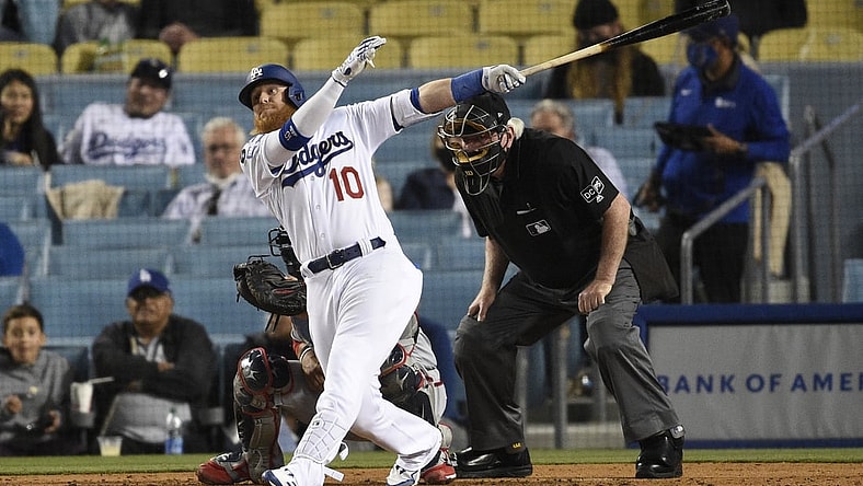 Apr 10, 2021; Los Angeles, California, USA; Los Angeles Dodgers third baseman Justin Turner (10) follows through on a swing for an RBI double during the fifth inning against the Washington Nationals at Dodger Stadium. Mandatory Credit: Kelvin Kuo-USA TODAY Sports