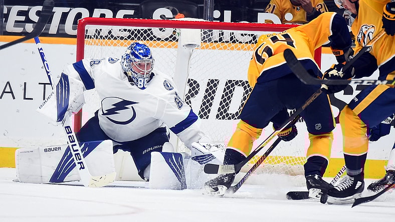 Apr 10, 2021; Nashville, Tennessee, USA; Tampa Bay Lightning goaltender Andrei Vasilevskiy (88) makes a save on a shot by Nashville Predators center Mikael Granlund (64) during the second period at Bridgestone Arena. Mandatory Credit: Christopher Hanewinckel-USA TODAY Sports