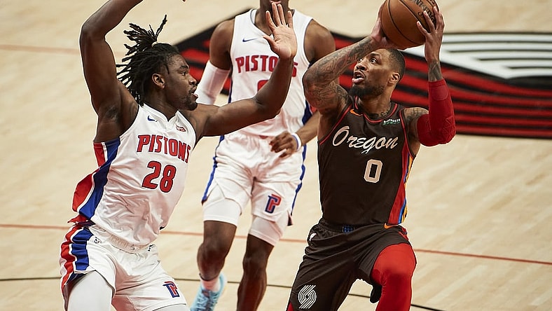 Apr 10, 2021; Portland, Oregon, USA; Portland Trail Blazers guard Damian Lillard (0) controls the ball against Detroit Pistons center Isaiah Stewart (28) during the first half at Moda Center. Mandatory Credit: Troy Wayrynen-USA TODAY Sports