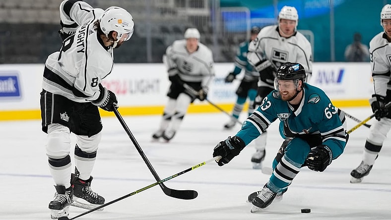 Apr 10, 2021; San Jose, California, USA;  San Jose Sharks left wing Jeffrey Truchon-Viel (63) defends against Los Angeles Kings defenseman Drew Doughty (8) during the first periodat SAP Center at San Jose. Mandatory Credit: Stan Szeto-USA TODAY Sports