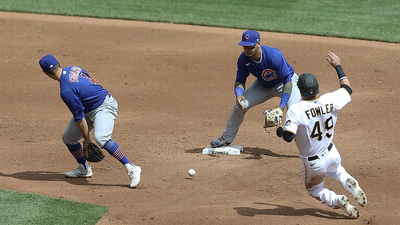 Apr 11, 2021; Pittsburgh, Pennsylvania, USA;  Chicago Cubs second baseman Eric Sogard (4) flips the ball between his legs to shortstop Javier Baez (9) for a forceout of Pittsburgh Pirates center fielder Dustin Fowler (49) at second base during the third inning at PNC Park. Mandatory Credit: Charles LeClaire-USA TODAY Sports
