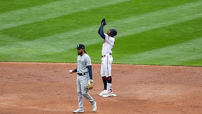 Apr 11, 2021; Minneapolis, Minnesota, USA; Minnesota Twins center fielder Byron Buxton (25) celebrates after hitting an RBI double in the third inning while Seattle Mariners shortstop J.P. Crawford (3) looks on at Target Field. Mandatory Credit: David Berding-USA TODAY Sports
