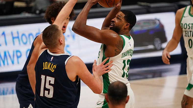 Apr 11, 2021; Denver, Colorado, USA;  Boston Celtics center Tristan Thompson (13) shoots the ball at Denver Nuggets center Nikola Jokic (15) in the second quarter at Ball Arena. Mandatory Credit: Ron Chenoy-USA TODAY Sports