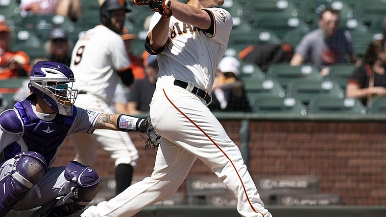 Apr 11, 2021; San Francisco, California, USA; San Francisco Giants batter Alex Dickerson (12) follows through on his solo home run again the Colorado Rockies during the first inning of a Major League Baseball game at Oracle Park. Mandatory Credit: D. Ross Cameron-USA TODAY Sports