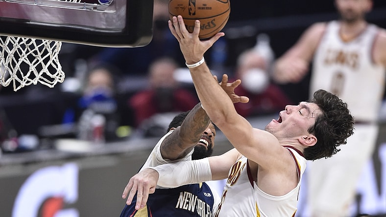 Apr 11, 2021; Cleveland, Ohio, USA; Cleveland Cavaliers forward Cedi Osman (16) goes to the basket while defended by New Orleans Pelicans forward James Johnson (16) during the second quarter at Rocket Mortgage FieldHouse. Mandatory Credit: David Richard-USA TODAY Sports