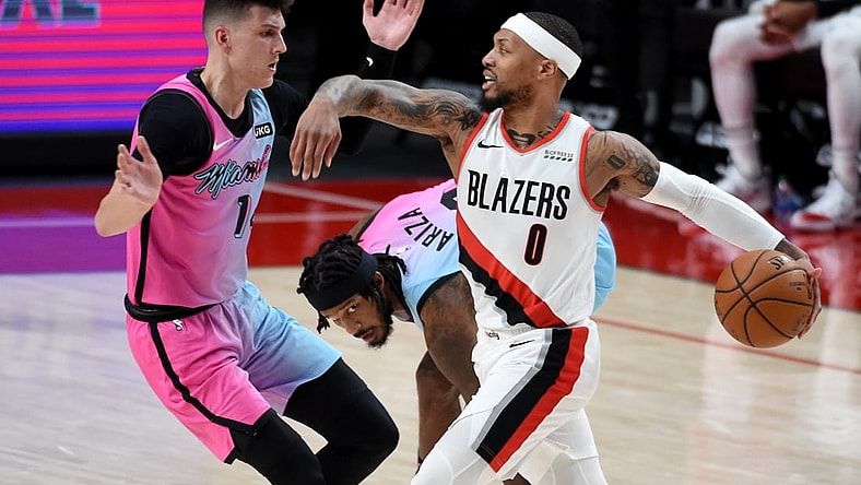 Apr 11, 2021; Portland, Oregon, USA; Portland Trail Blazers guard Damian Lillard (0) drives to the basket on Miami Heat guard Tyler Herro (14) during the first half of the game at Moda Center. Mandatory Credit: Steve Dykes-USA TODAY Sports