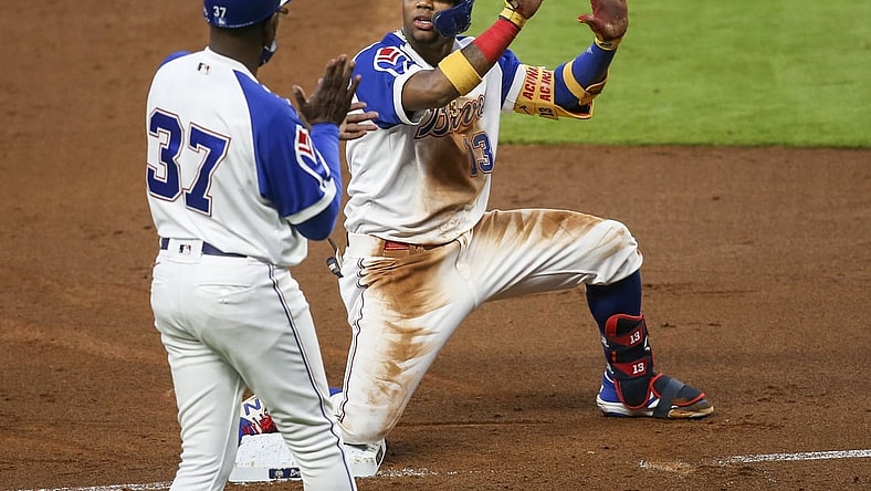 Apr 12, 2021; Atlanta, Georgia, USA; Atlanta Braves right fielder Ronald Acuna Jr. (13) asks for time out in front of third base coach Ron Washington (37) after a triple against the Miami Marlins in the third inning at Truist Park. Mandatory Credit: Brett Davis-USA TODAY Sports