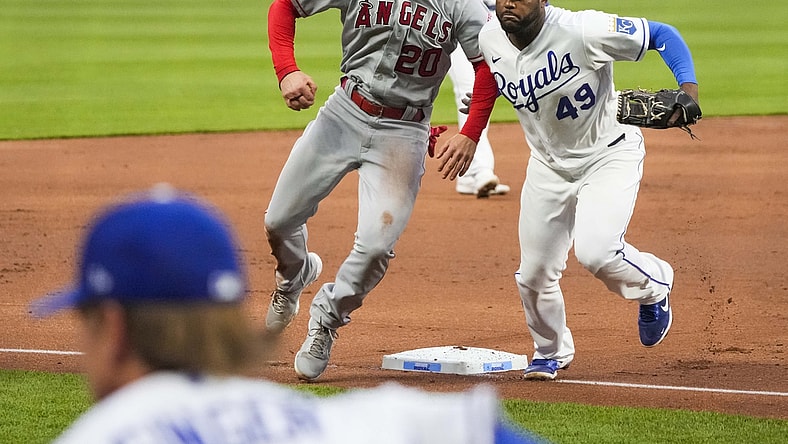 Apr 12, 2021; Kansas City, Missouri, USA; Los Angeles Angels first baseman Jared Walsh (20) avoids colliding with Kansas City Royals third baseman Hanser Alberto (49) during the second inning at Kauffman Stadium. Mandatory Credit: Jay Biggerstaff-USA TODAY Sports