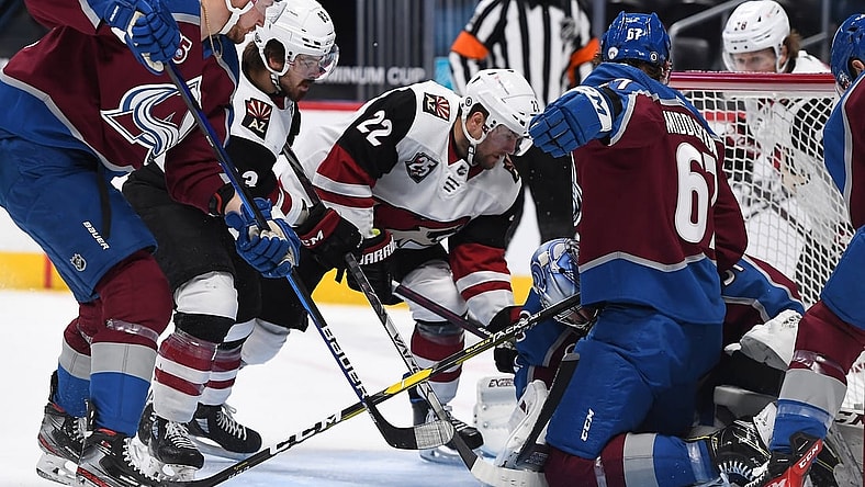 Apr 12, 2021; Denver, Colorado, USA; Arizona Coyotes left wing Johan Larsson (22) and right wing Conor Garland (83) attempt to score against Colorado Avalanche goaltender Philipp Grubauer (31) and defenseman Keaton Middleton (67) in the first period at Ball Arena. Mandatory Credit: Ron Chenoy-USA TODAY Sports