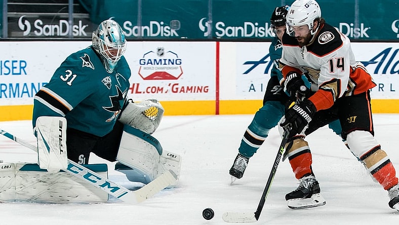 Apr 12, 2021; San Jose, California, USA; Anaheim Ducks center Adam Henrique (14) shoots the puck against San Jose Sharks goaltender Martin Jones (31) in the first period at SAP Center at San Jose. Mandatory Credit: John Hefti-USA TODAY Sports