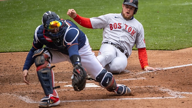 Apr 13, 2021; Minneapolis, Minnesota, USA; Boston Red Sox second baseman Christian Arroyo (39) slides safely into home plate before Minnesota Twins catcher Mitch Garver (8) can catch the ball and make a tag in the fifth inning at Target Field. Mandatory Credit: Jesse Johnson-USA TODAY Sports