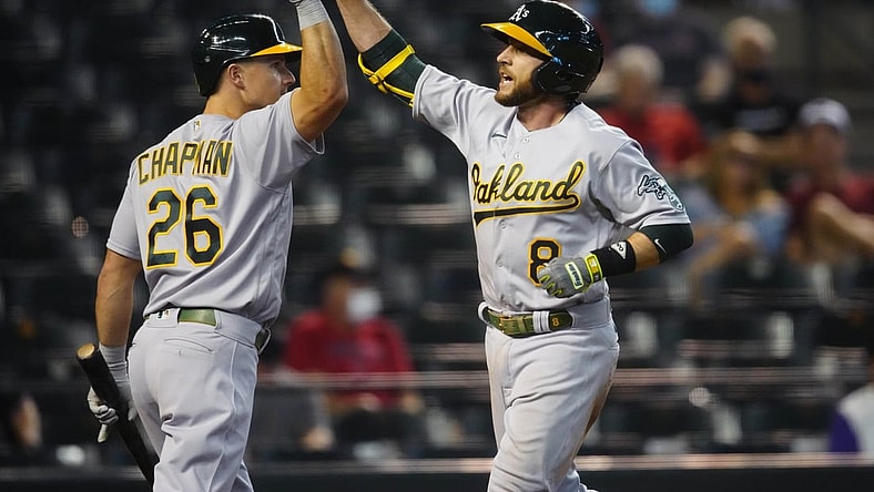 Apr 13, 2021; Phoenix, Arizona, USA; Oakland Athletics infielder Jed Lowrie (8) celebrates with teammate Matt Chapman after hitting a three run home run in the seventh inning against the Arizona Diamondbacks at Chase Field. Mandatory Credit: Mark J. Rebilas-USA TODAY Sports