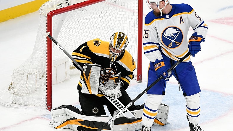 Apr 13, 2021; Boston, Massachusetts, USA; Boston Bruins goaltender Jeremy Swayman (1) makes a save in front of Buffalo Sabres defenseman Rasmus Ristolainen (55) during the first period at TD Garden. Mandatory Credit: Brian Fluharty-USA TODAY Sports