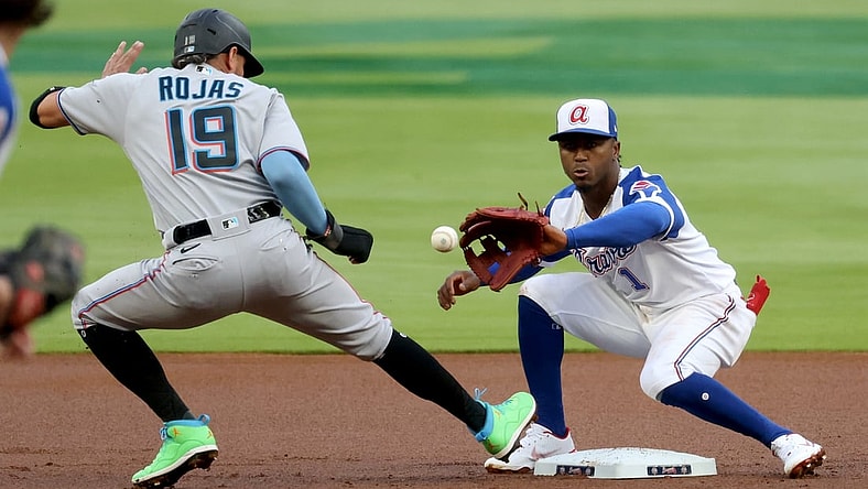 Apr 13, 2021; Atlanta, Georgia, USA; Miami Marlins shortstop Miguel Rojas (19) is safe at second base on a pickoff attempt by Atlanta Braves second baseman Ozzie Albies (1) during the first inning at Truist Park. Mandatory Credit: Jason Getz-USA TODAY Sports