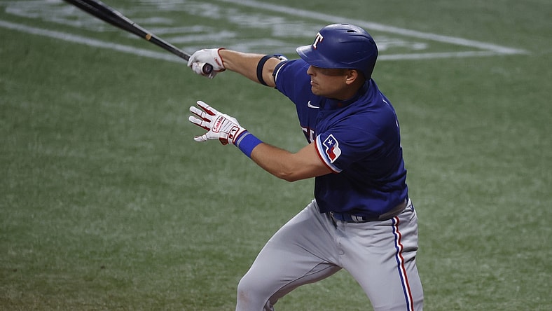 Apr 13, 2021; St. Petersburg, Florida, USA;  Texas Rangers first baseman Nate Lowe (30) singles against the Tampa Bay Rays during the fourth inning at Tropicana Field. Mandatory Credit: Kim Klement-USA TODAY Sports