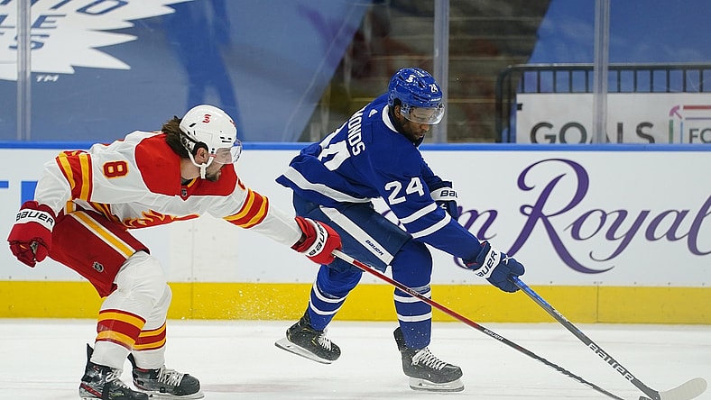 Apr 13, 2021; Toronto, Ontario, CAN; Calgary Flames defenseman Christopher Tanev (8) defends against Toronto Maple Leafs forward Wayne Simmonds (24) during the first period at Scotiabank Arena. Mandatory Credit: John E. Sokolowski-USA TODAY Sports