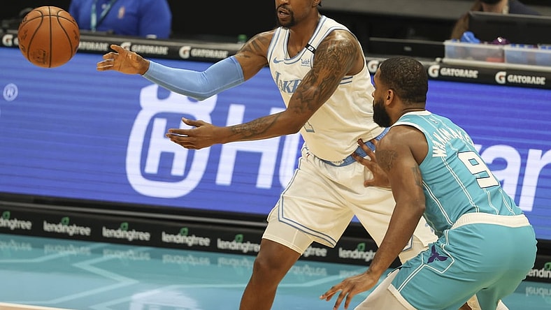 Apr 13, 2021; Charlotte, North Carolina, USA; Los Angeles Lakers guard Kentavious Caldwell-Pope (1) passes away from Charlotte Hornets guard Brad Wanamaker (9) during the first quarter at Spectrum Center. Mandatory Credit: Nell Redmond-USA TODAY Sports
