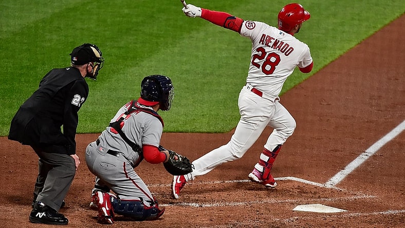 Apr 13, 2021; St. Louis, Missouri, USA;  St. Louis Cardinals third baseman Nolan Arenado (28) hits a two run home run during the third inning against the Washington Nationals at Busch Stadium. Mandatory Credit: Jeff Curry-USA TODAY Sports