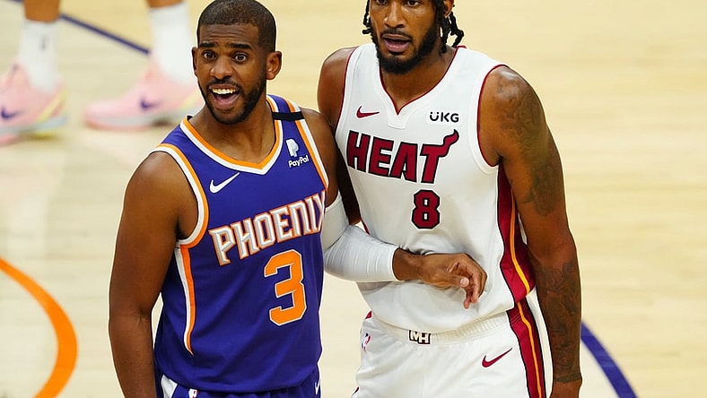 Apr 13, 2021; Phoenix, Arizona, USA; Phoenix Suns guard Chris Paul (3) against Miami Heat forward Trevor Ariza (8) in the first half at Phoenix Suns Arena. Mandatory Credit: Mark J. Rebilas-USA TODAY Sports