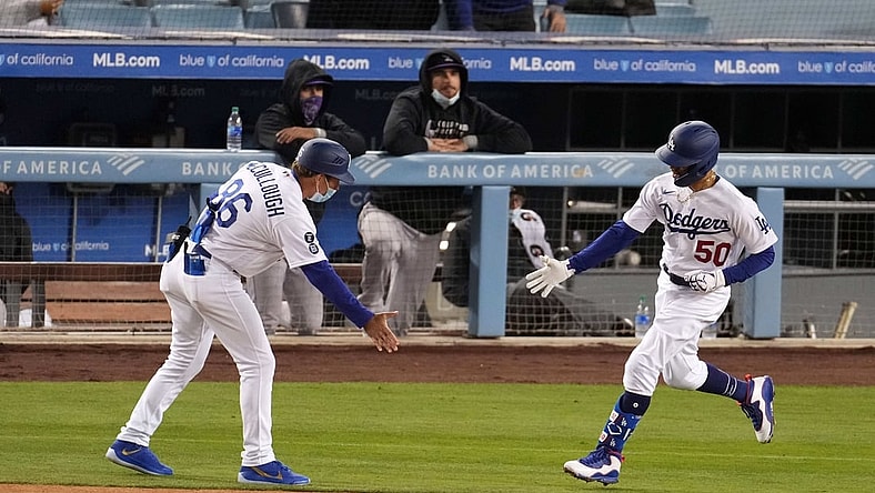 Apr 13, 2021; Los Angeles, California, USA; Los Angeles Dodgers right fielder Mookie Betts (50) is congratulated by first base coach Clayton McCullough (L) after hitting a home run during the third inning against the Colorado Rockies at Dodger Stadium. Mandatory Credit: Kirby Lee-USA TODAY Sports