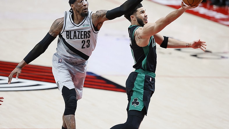 Apr 13, 2021; Portland, Oregon, USA; Boston Celtics small forward Jayson Tatum (right) shoots the ball against Portland Trail Blazers power forward Robert Covington (23) during the second half at Moda Center. Mandatory Credit: Soobum Im-USA TODAY Sports