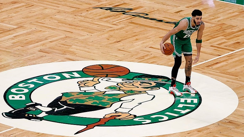 Apr 7, 2021; Boston, Massachusetts, USA; Boston Celtics forward Jayson Tatum (0) brings the ball up past half court over the Celtics logo during the third quarter against the New York Knicks at TD Garden. Mandatory Credit: Winslow Townson-USA TODAY Sports