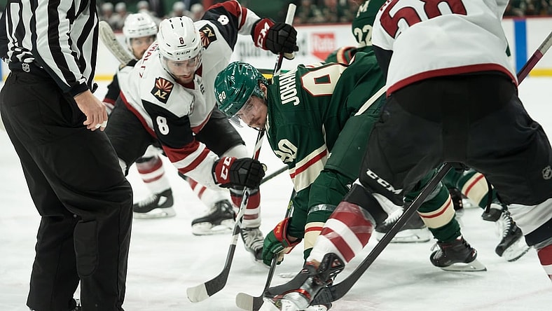 Apr 14, 2021; Saint Paul, Minnesota, USA;  Arizona Coyotes center Nick Schmaltz (8) and Minnesota Wild center Marcus Johansson (90) face off as Arizona Coyotes left wing Michael Bunting (58) and Minnesota Wild left wing Kevin Fiala (22) and linesman Devin Berg (87) watch at Xcel Energy Center. Mandatory Credit: Matt Blewett-USA TODAY Sports