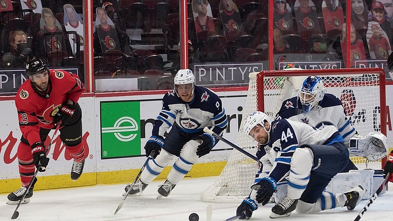 Apr 14, 2021; Ottawa, Ontario, CAN; Ottawa Senators center Michael Amadiao (29) shoots the puck past Winnipeg Jets defenseman Josh Morrissey (44) during the first period at the Canadian Tire Centre. Mandatory Credit: Marc DesRosiers-USA TODAY Sports