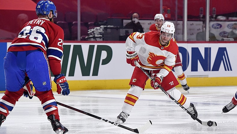 Apr 14, 2021; Montreal, Quebec, CAN; Calgary Flames forward Johnny Gaudreau (13) shoots the puck and Montreal Canadiens defenseman Jeff Petry (26) attempts to block during the first period at the Bell Centre. Mandatory Credit: Eric Bolte-USA TODAY Sports