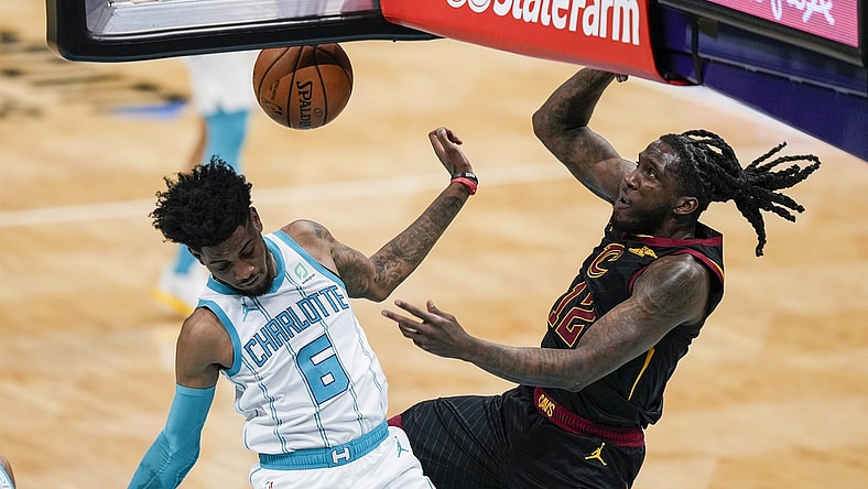 Apr 14, 2021; Charlotte, North Carolina, USA; Cleveland Cavaliers forward Taurean Prince (12) gets a dunk defended by Charlotte Hornets forward Jalen McDaniels (6) during the second quarter at the Spectrum Center. Mandatory Credit: Jim Dedmon-USA TODAY Sports