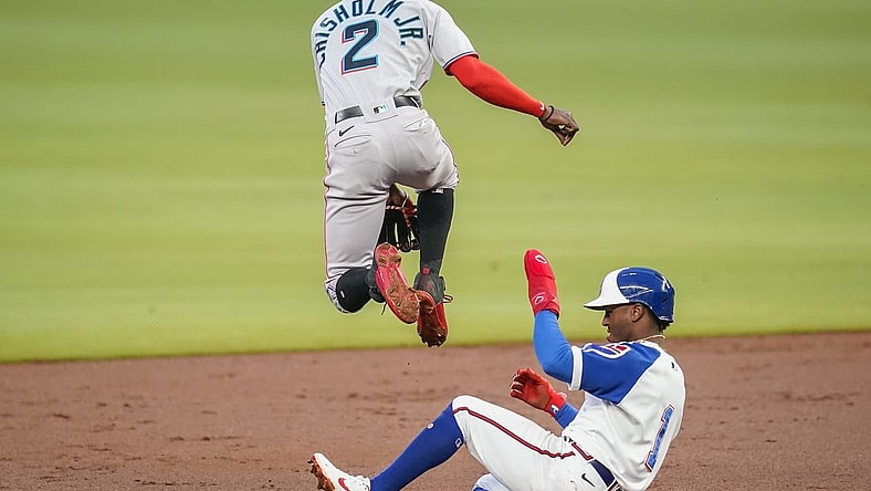 Apr 14, 2021; Cumberland, Georgia, USA; Miami Marlins second baseman Jazz Chisholm Jr. (2) jumps over Atlanta Braves second baseman Ozzie Albies (1) as he throws to first base to complete a double play during the second inning at Truist Park. Mandatory Credit: Dale Zanine-USA TODAY Sports
