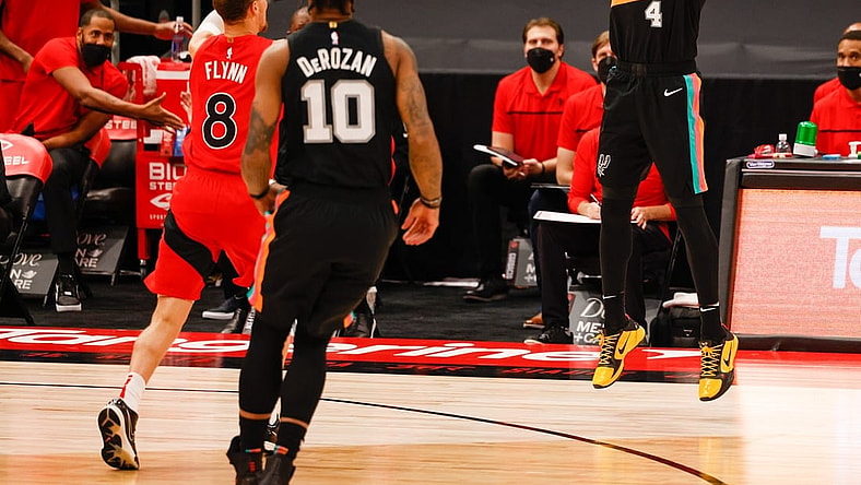 Apr 14, 2021; Tampa, Florida, USA;  San Antonio Spurs guard Derrick White (4) shoots from the three point line in the first quarter at Amalie Arena. Mandatory Credit: Nathan Ray Seebeck-USA TODAY Sports